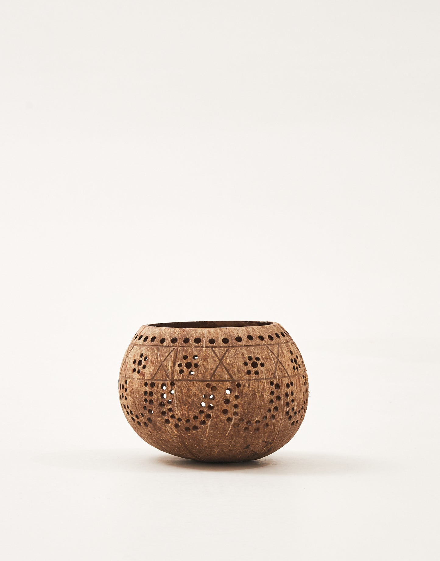 Coconut candle holder with perforations